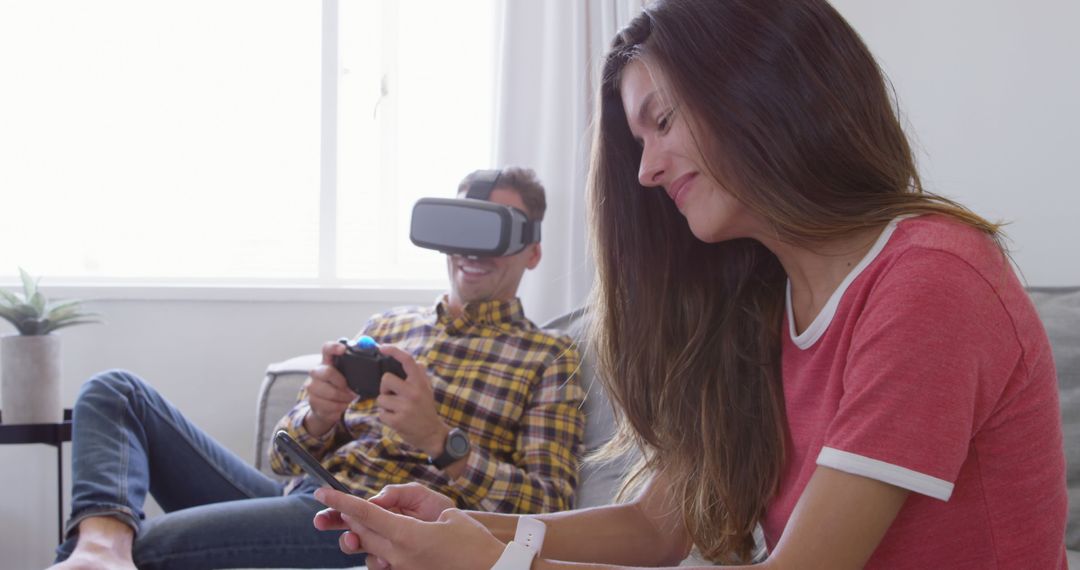 Young Couple Enjoying VR and Smartphone Technology at Home - Free Images, Stock Photos and Pictures on Pikwizard.com