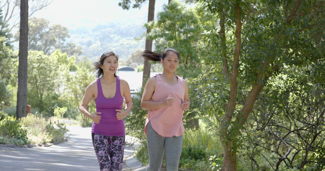 Two Women Jogging on Sunny Outdoor Trail in Nature Park - Free Images, Stock Photos and Pictures on Pikwizard.com