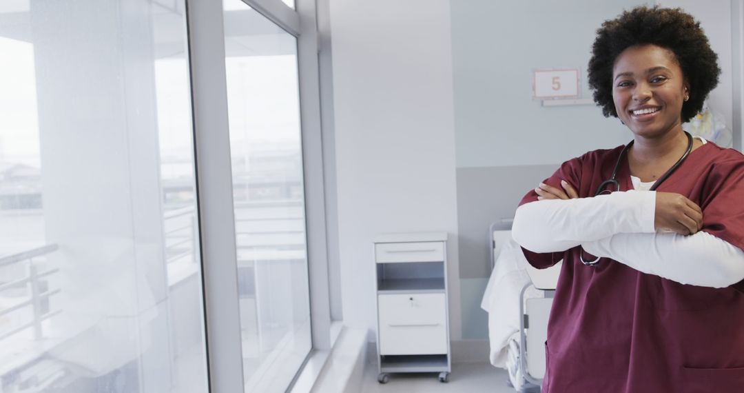 Confident African American Female Nurse Standing in Hospital - Free Images, Stock Photos and Pictures on Pikwizard.com