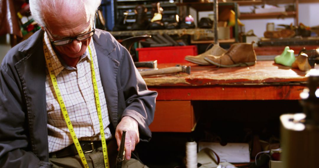 Elderly Craftsman Working in Shoe Repair Workshop - Free Images, Stock Photos and Pictures on Pikwizard.com