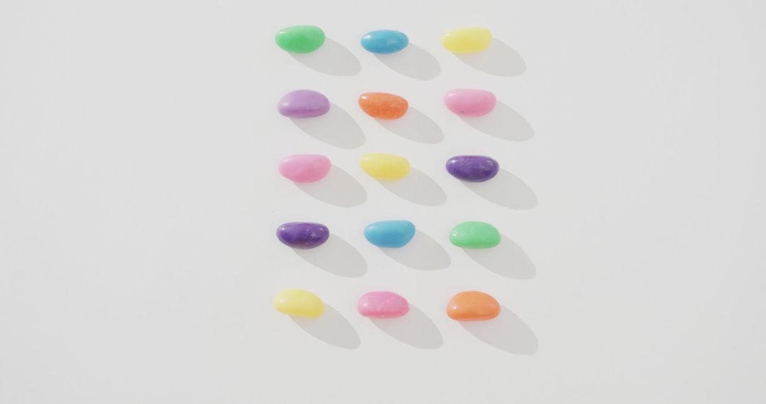 Colorful Jelly Beans Arranged in Neat Rows on White Background - Free Images, Stock Photos and Pictures on Pikwizard.com