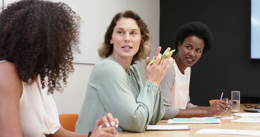 Diverse Female Team Discussing Ideas in Modern Office Setting