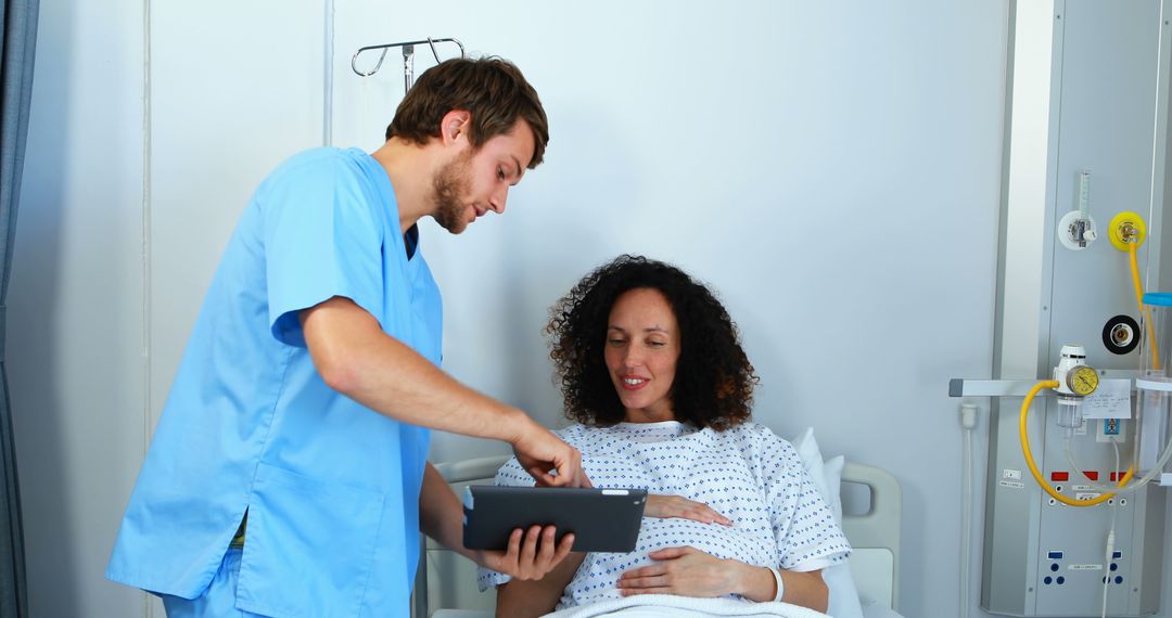 Nurse Assisting Smiling Pregnant Patient in Hospital Bed - Free Images, Stock Photos and Pictures on Pikwizard.com