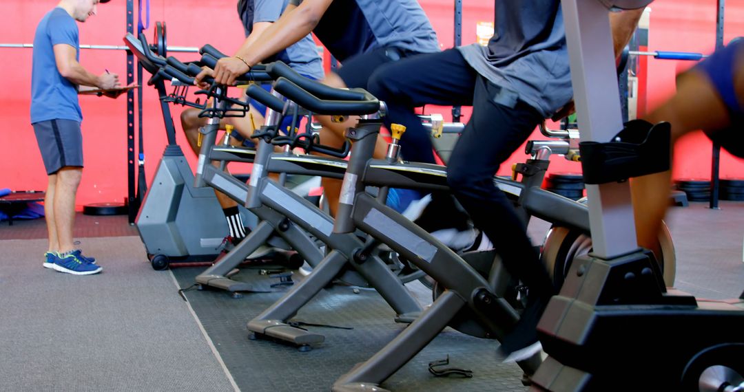 People Spinning on Exercise Bikes in Fitness Class - Free Images, Stock Photos and Pictures on Pikwizard.com