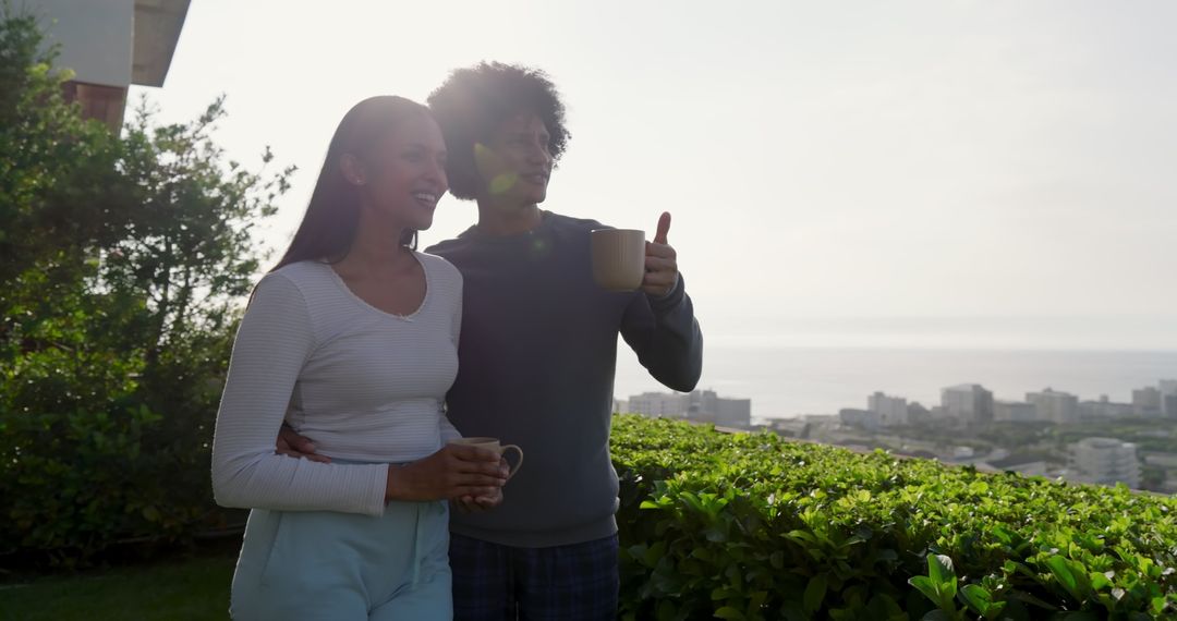 Couple Enjoying Scenic Rooftop View with Coffee Mugs