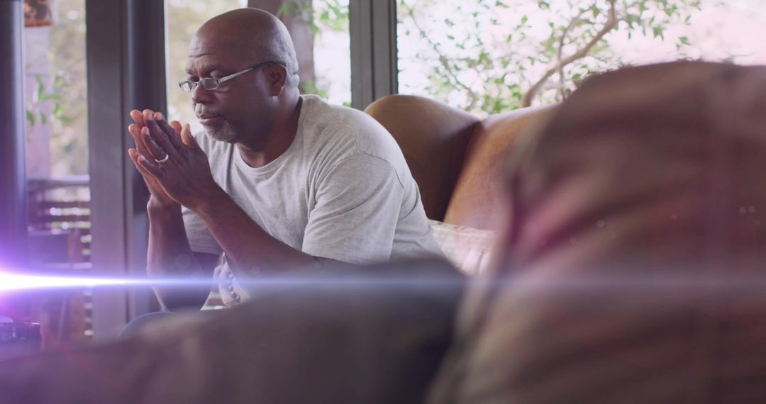 Senior Man Contemplating Serenity in Cozy Home
