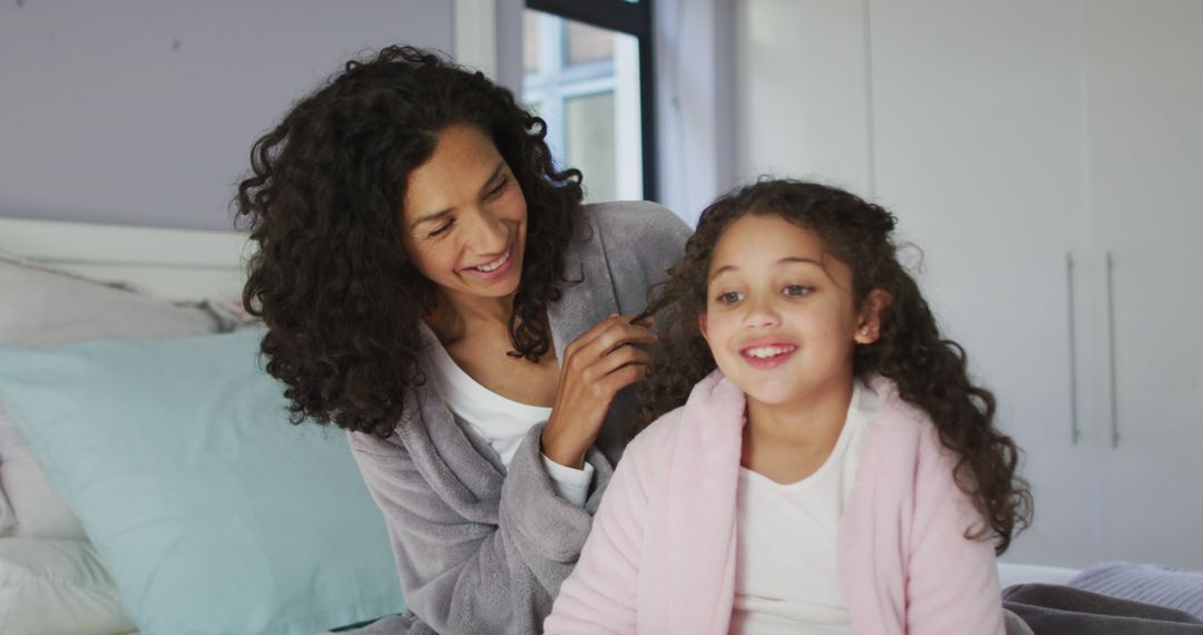 Smiling Mother Combing Daughter's Hair In Cozy Home - Free Images, Stock Photos and Pictures on Pikwizard.com