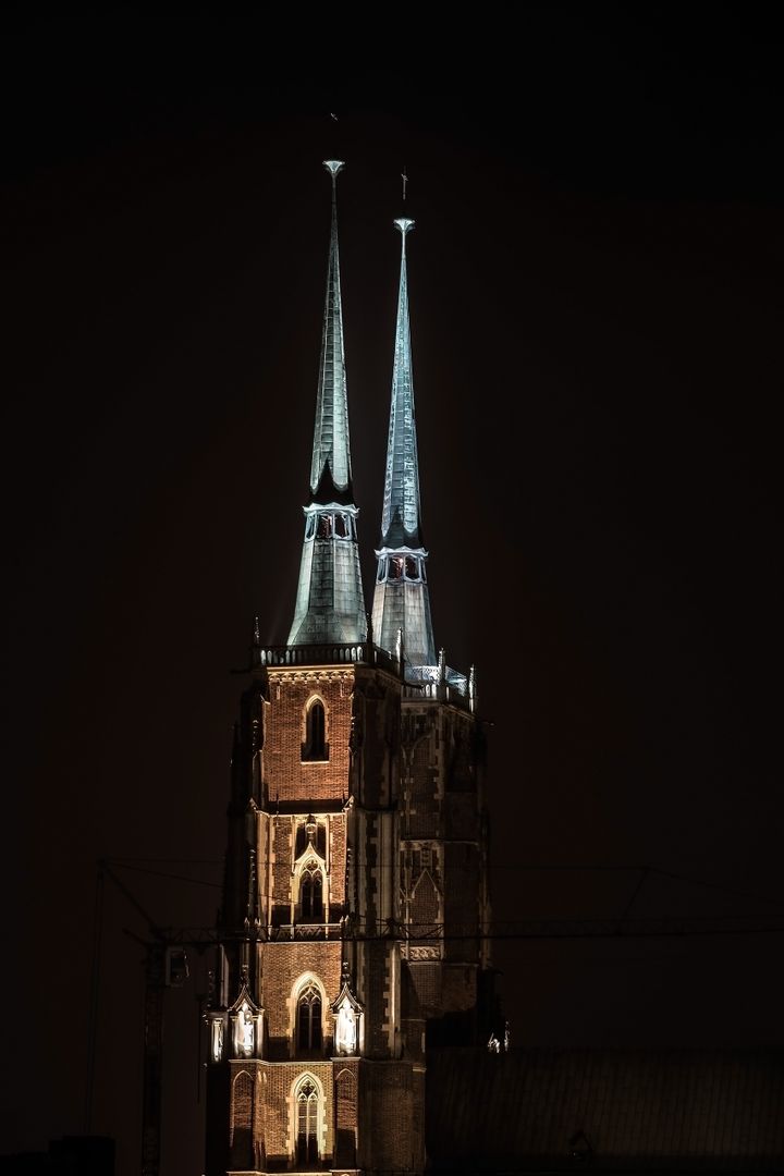 Illuminated Twin Spires of Gothic Cathedral at Night - Free Images, Stock Photos and Pictures on Pikwizard.com