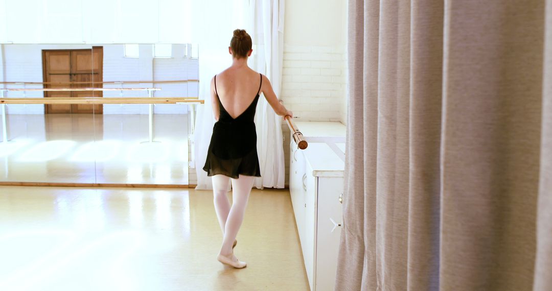 Young Ballerina Practicing at Barre in Ballet Studio - Free Images, Stock Photos and Pictures on Pikwizard.com