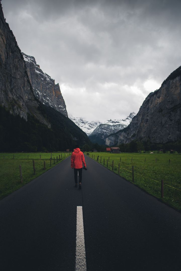 Solo Traveler Walking on Scenic Mountain Road