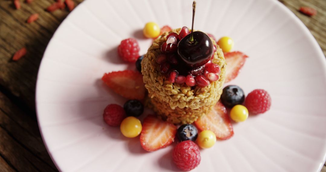 Beautifully Plated Granola Tower with Fresh Berries and Pomegranate - Free Images, Stock Photos and Pictures on Pikwizard.com