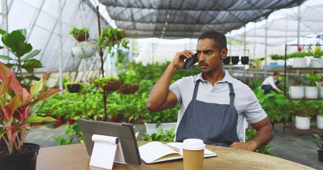 Botanist in Greenhouse Using Technology Tools for Plant Care