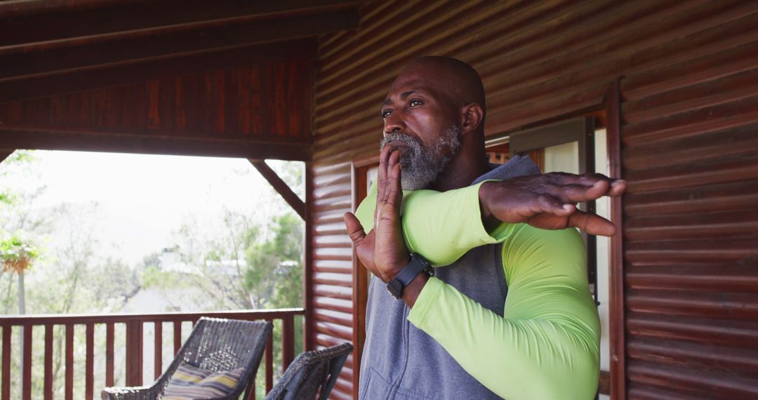 Mature African American Man Stretching on Wooden Porch - Free Images, Stock Photos and Pictures on Pikwizard.com