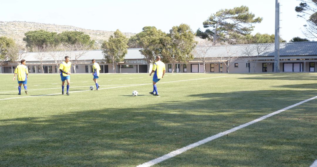 Soccer Team Practicing Passing Drills on Sunny School Field