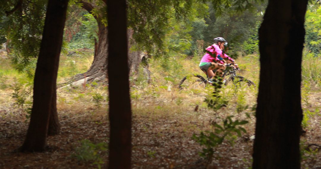 Woman Mountain Biking Through Forest Trail in Summer - Free Images, Stock Photos and Pictures on Pikwizard.com