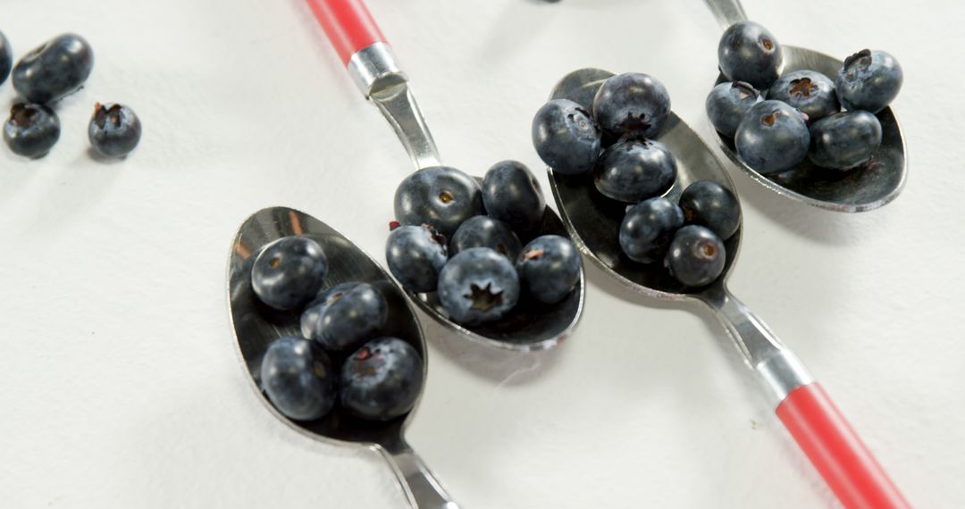 Fresh Blueberries on Spoons with Red Handles on White Background - Free Images, Stock Photos and Pictures on Pikwizard.com