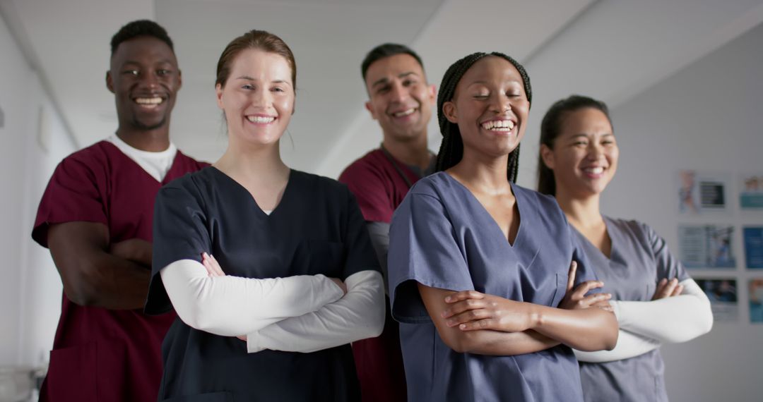 Diverse Group of Medical Professionals Smiling in Hospital Corridor - Free Images, Stock Photos and Pictures on Pikwizard.com