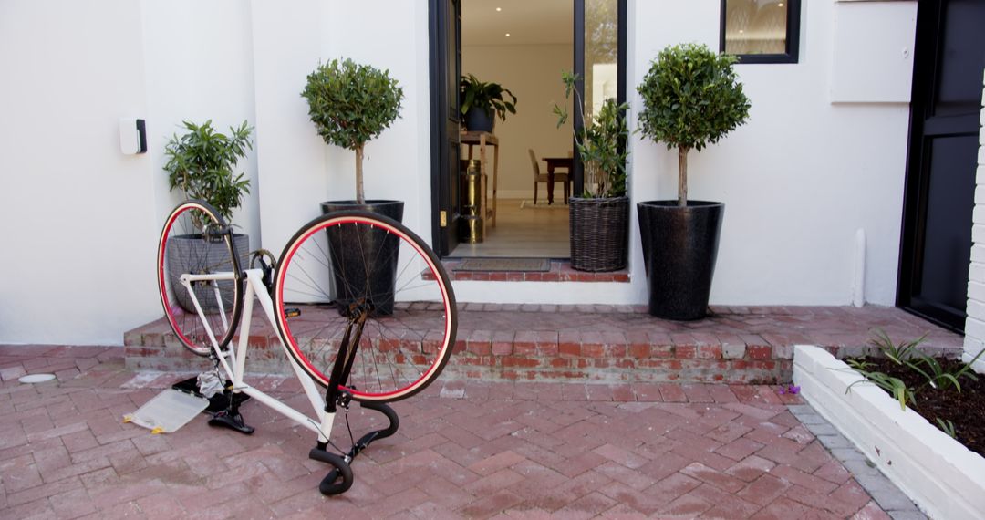 Upside Down Bicycle on Brick Patio with Decorated Entrance