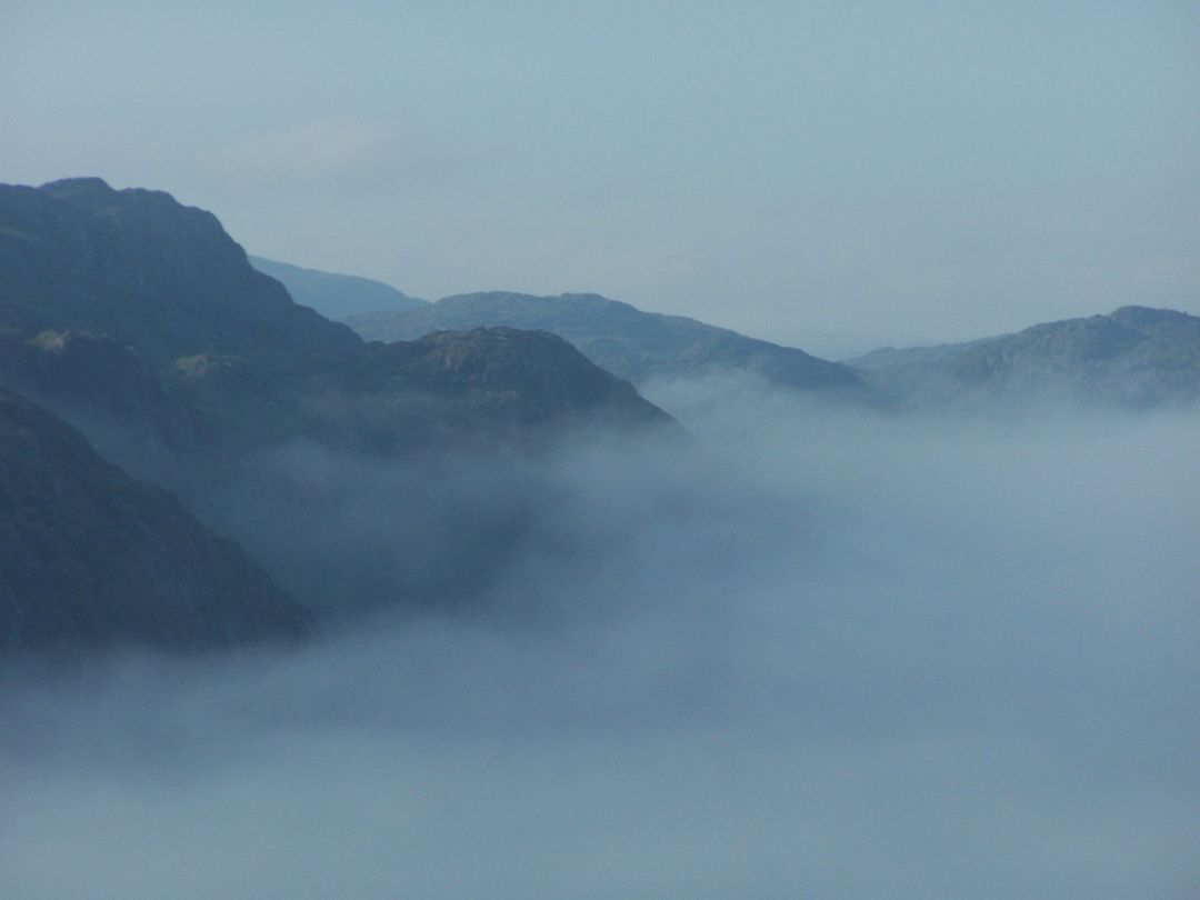Misty Mountains with Dense Fog and Blue Sky - Free Images, Stock Photos and Pictures on Pikwizard.com