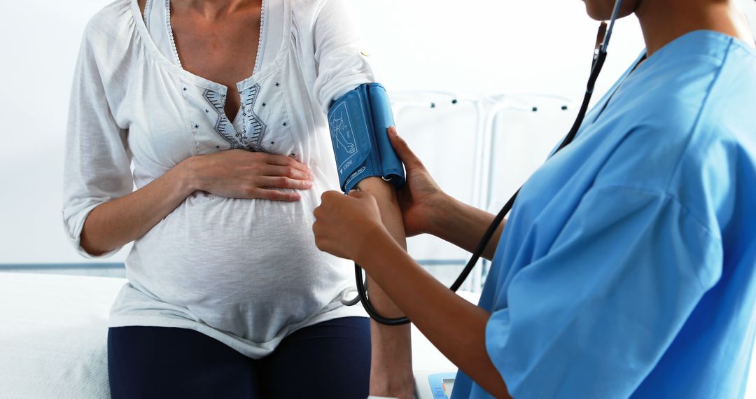 Pregnant Woman Having Blood Pressure Checked by Doctor - Free Images, Stock Photos and Pictures on Pikwizard.com