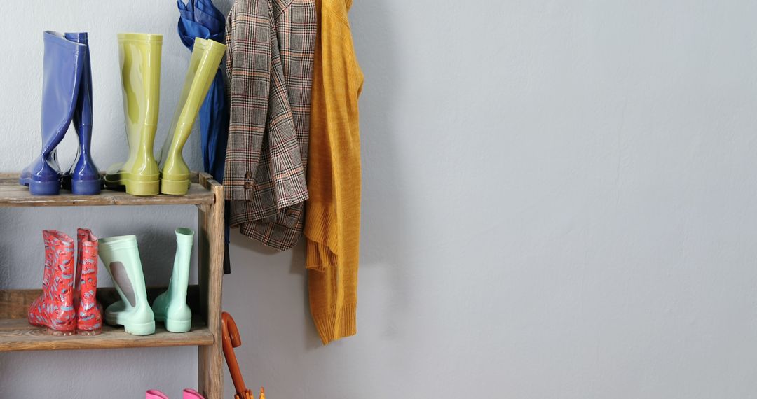 Cozy Mudroom with Colorful Rain Boots and Jackets on Wooden Rack - Free Images, Stock Photos and Pictures on Pikwizard.com