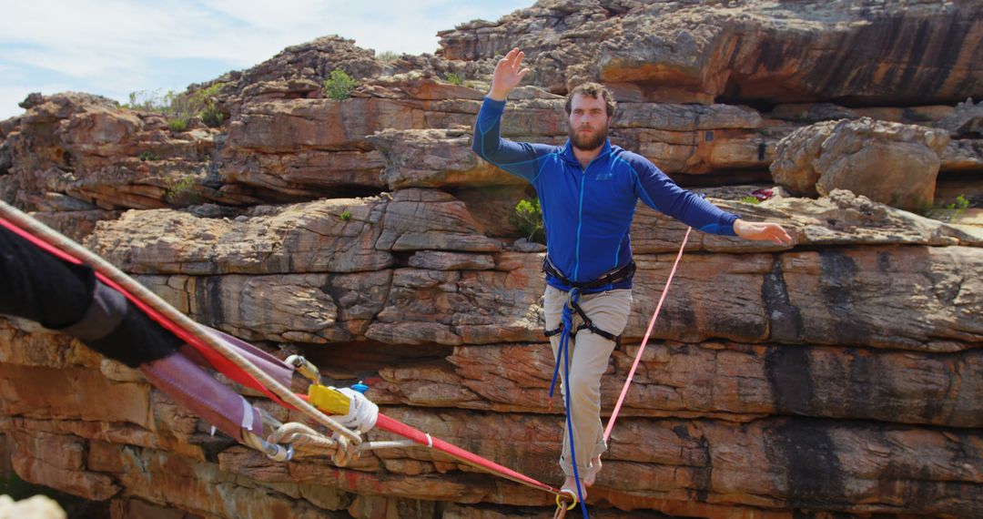 Man Balancing on Tightrope Amidst Rocky Landscape - Free Images, Stock Photos and Pictures on Pikwizard.com