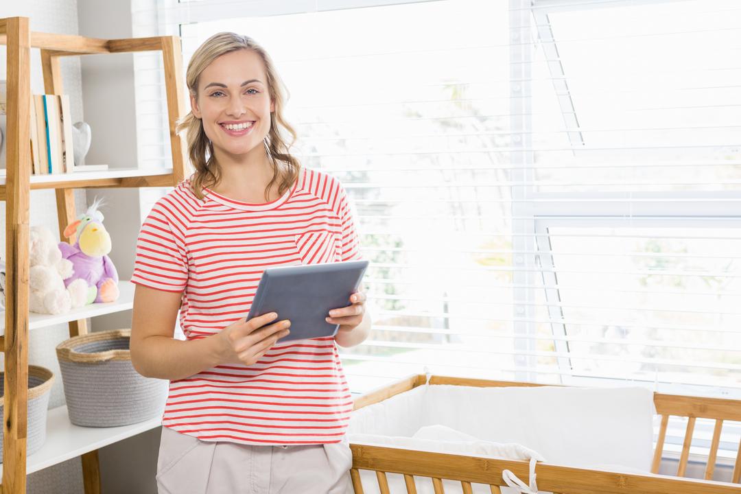 Smiling Woman Holding Digital Tablet in Bright Home - Free Images, Stock Photos and Pictures on Pikwizard.com