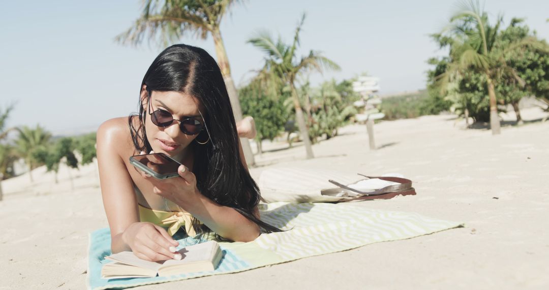 Young Woman Reading Book and Talking on Phone at Beach - Free Images, Stock Photos and Pictures on Pikwizard.com