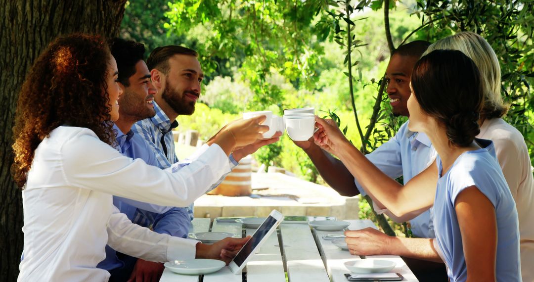 Diverse Friends Toasting Coffee In Summer Garden Gathering - Free Images, Stock Photos and Pictures on Pikwizard.com