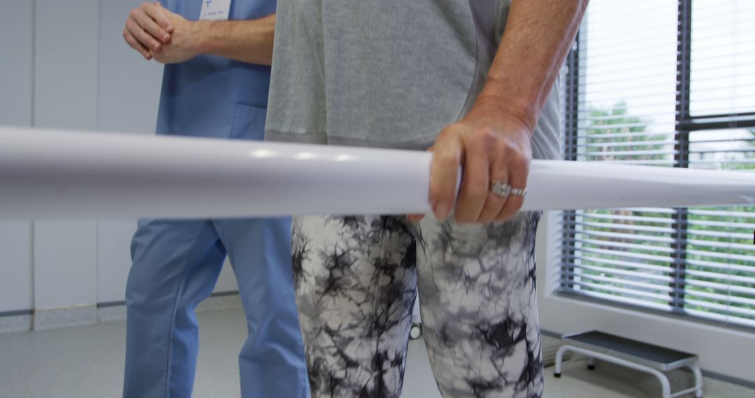 Senior Patient in Physical Therapy Holding Parallel Bars - Free Images, Stock Photos and Pictures on Pikwizard.com