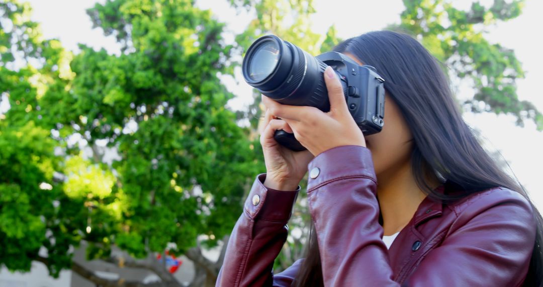 Woman Photographing Outdoors with Professional Camera - Free Images, Stock Photos and Pictures on Pikwizard.com