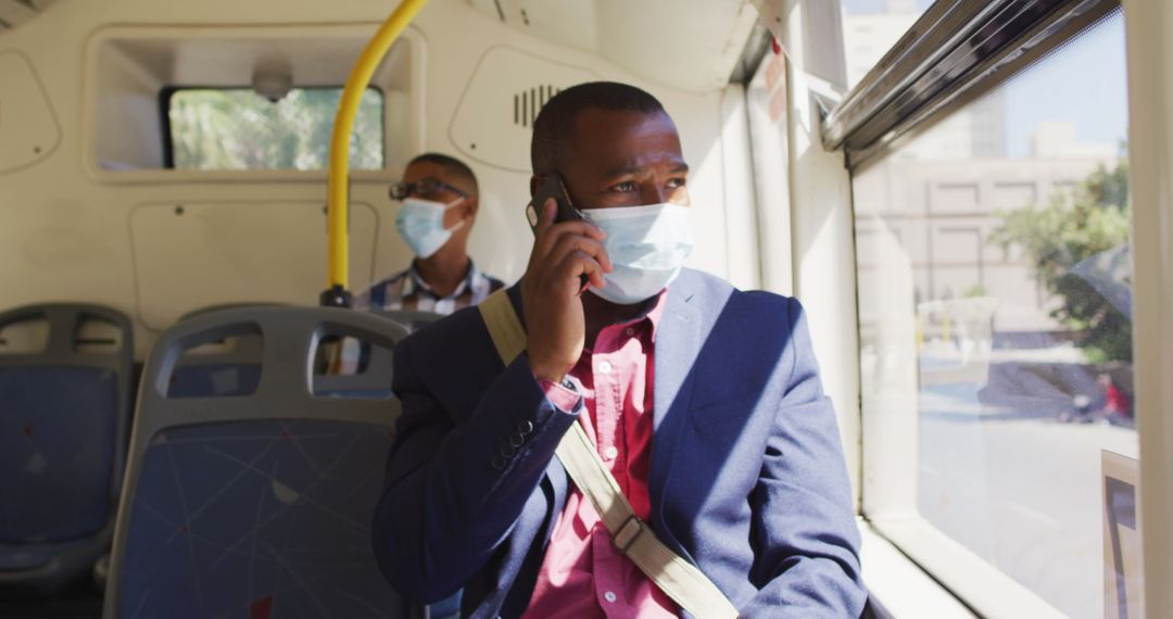 Man in Bus Wearing Mask and Using Smartphone for Communication