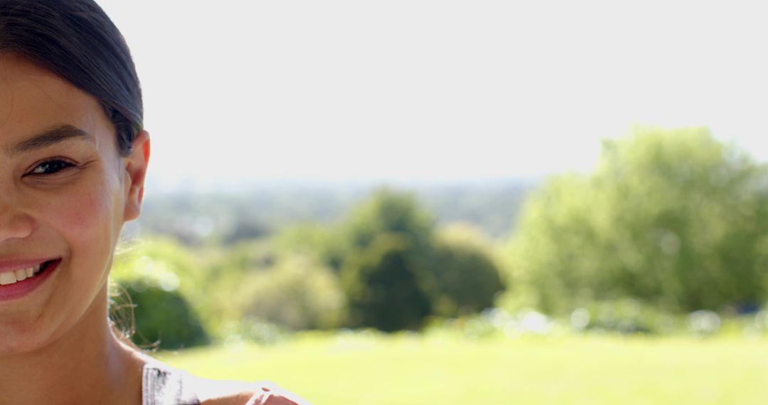 Smiling Person Relaxing on Sunny Day with Lush Greenery