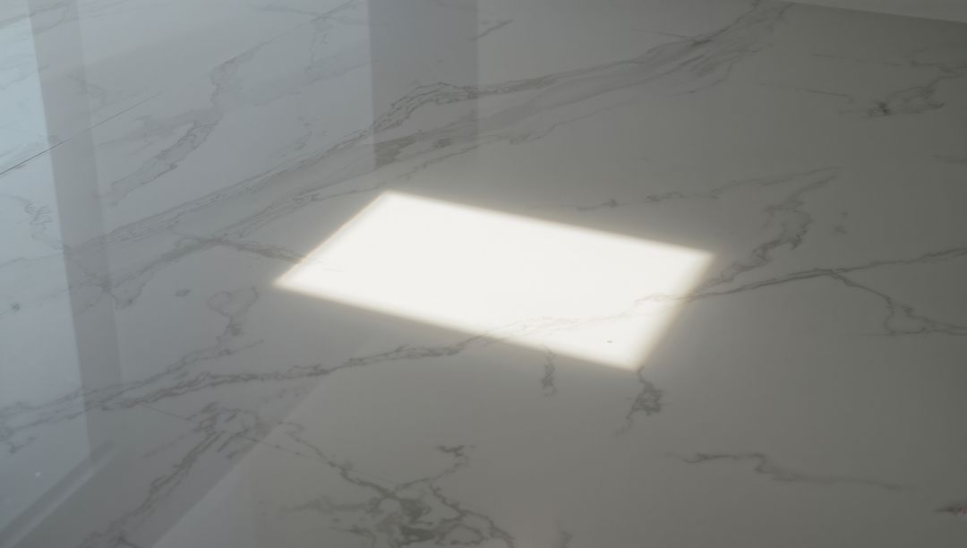 Showing Rectangular Sunlight Patch on Polished White Marble Countertop with Window Shadow