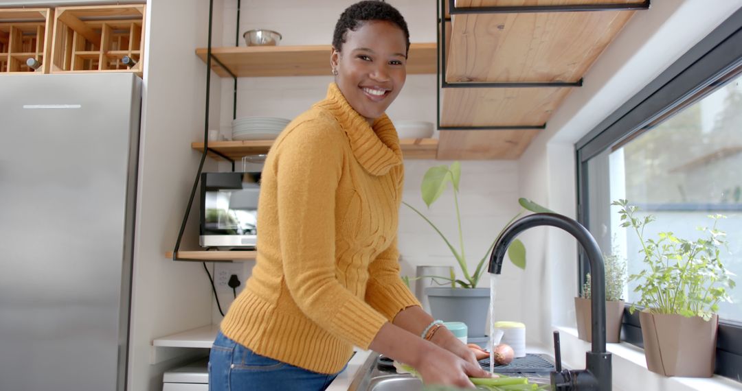 Smiling Woman Washing Vegetables in Modern Kitchen - Free Images, Stock Photos and Pictures on Pikwizard.com