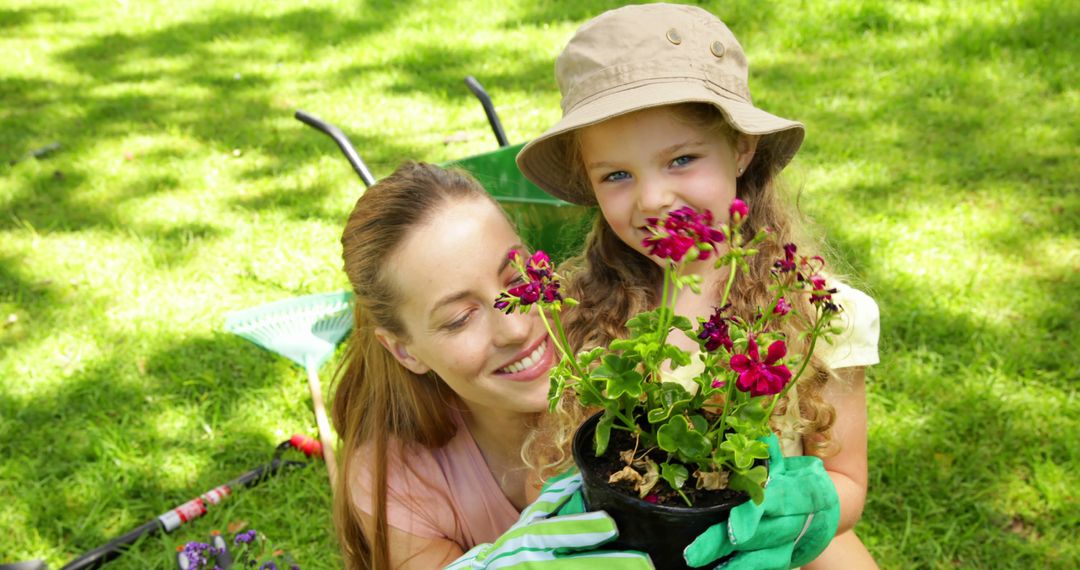 Mother and Daughter Planting Flowers Outdoors - Free Images, Stock Photos and Pictures on Pikwizard.com