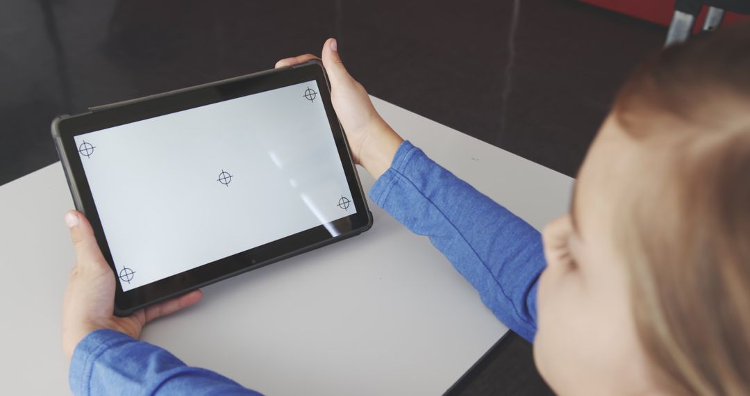 Child in Classroom Holding Tablet with Blank Screen