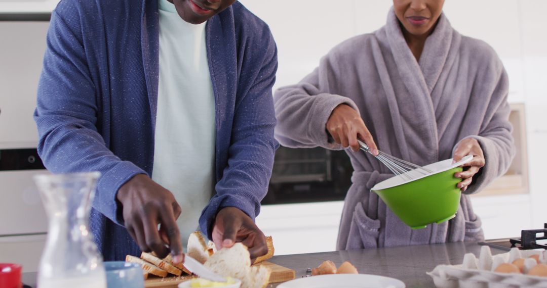 Image of happy african american couple preparing breakfast together in kitchen - Free Images, Stock Photos and Pictures on Pikwizard.com