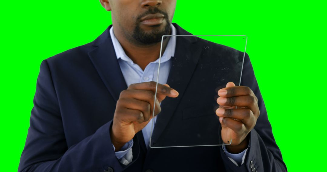 Businessman Using Transparent Tablet with Green Screen Background - Free Images, Stock Photos and Pictures on Pikwizard.com