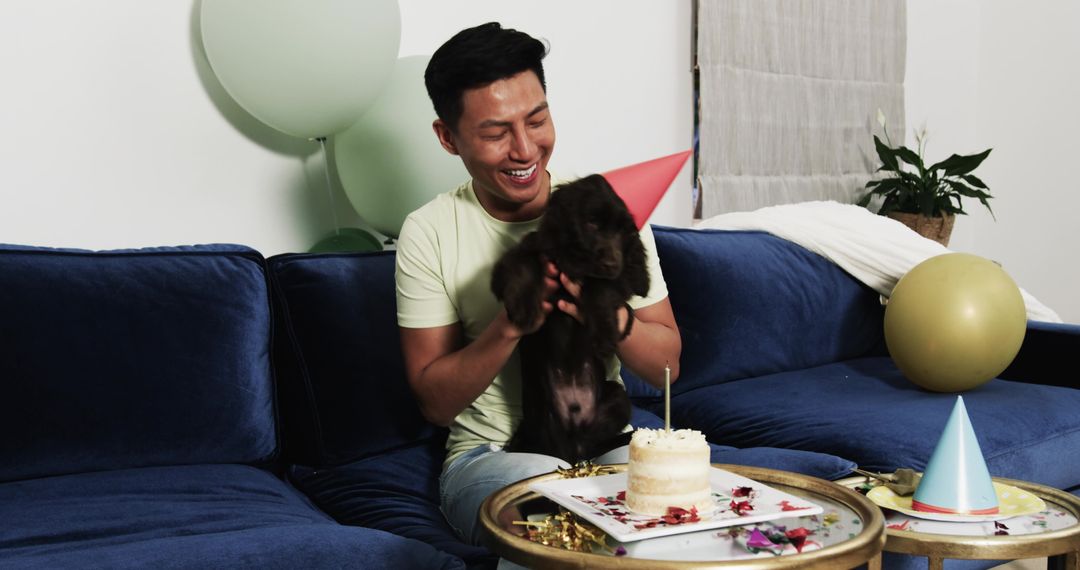 Man Celebrates Puppy Birthday with Cake and Party Hats