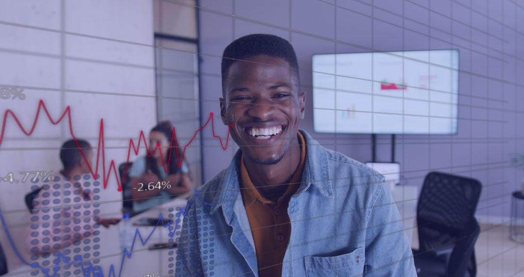 Smiling African American Businessman in Office with Financial Graphs Overlay - Free Images, Stock Photos and Pictures on Pikwizard.com