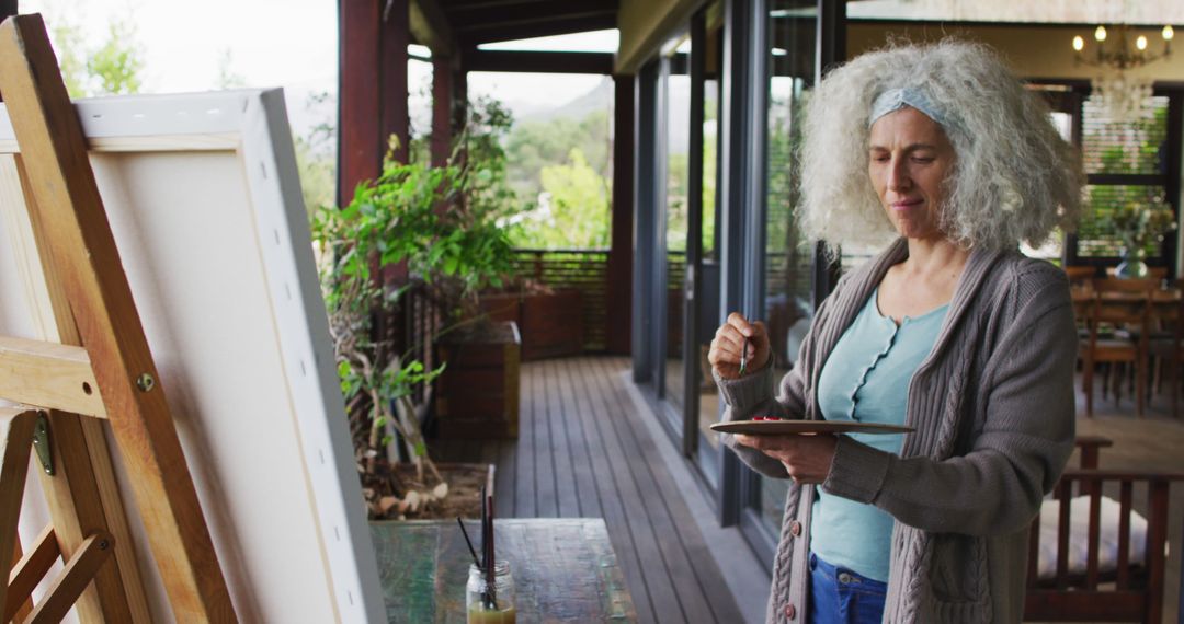 Senior Woman Painting on Outdoor Deck - Free Images, Stock Photos and Pictures on Pikwizard.com