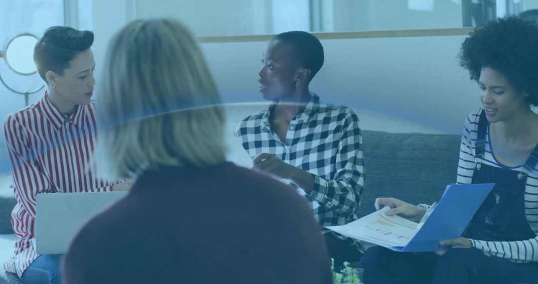 Diverse Office Team Collaborating in Modern Lounge