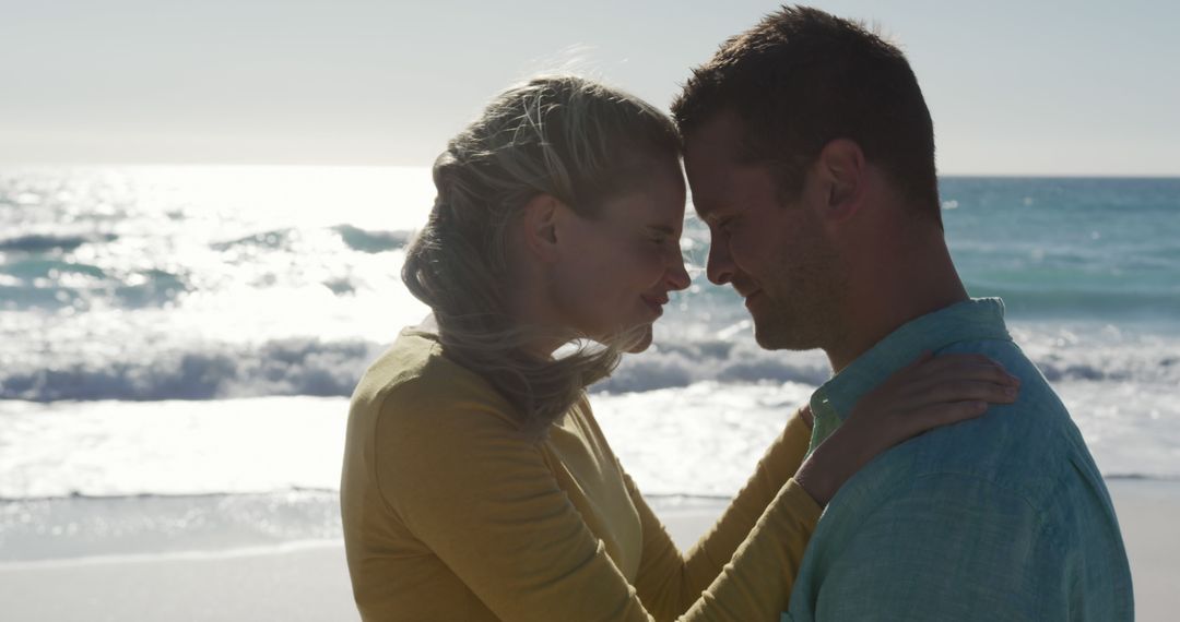 Romantic Couple Embracing on Beach During Sunset - Free Images, Stock Photos and Pictures on Pikwizard.com