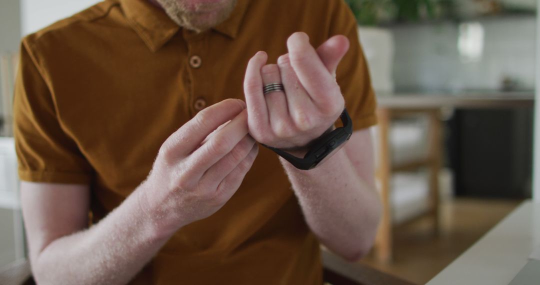 Man Setting Up Smartwatch in Modern Kitchen - Free Images, Stock Photos and Pictures on Pikwizard.com