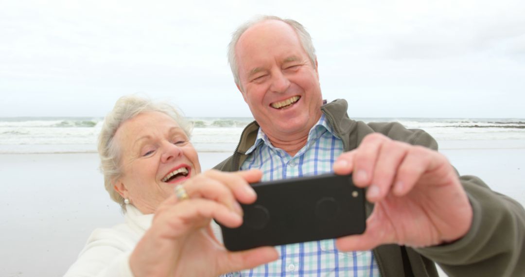 Happy Senior Couple Taking Selfie on Beach - Free Images, Stock Photos and Pictures on Pikwizard.com