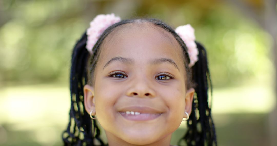 Smiling African American Girl with Braids and Hair Accessories - Free Images, Stock Photos and Pictures on Pikwizard.com