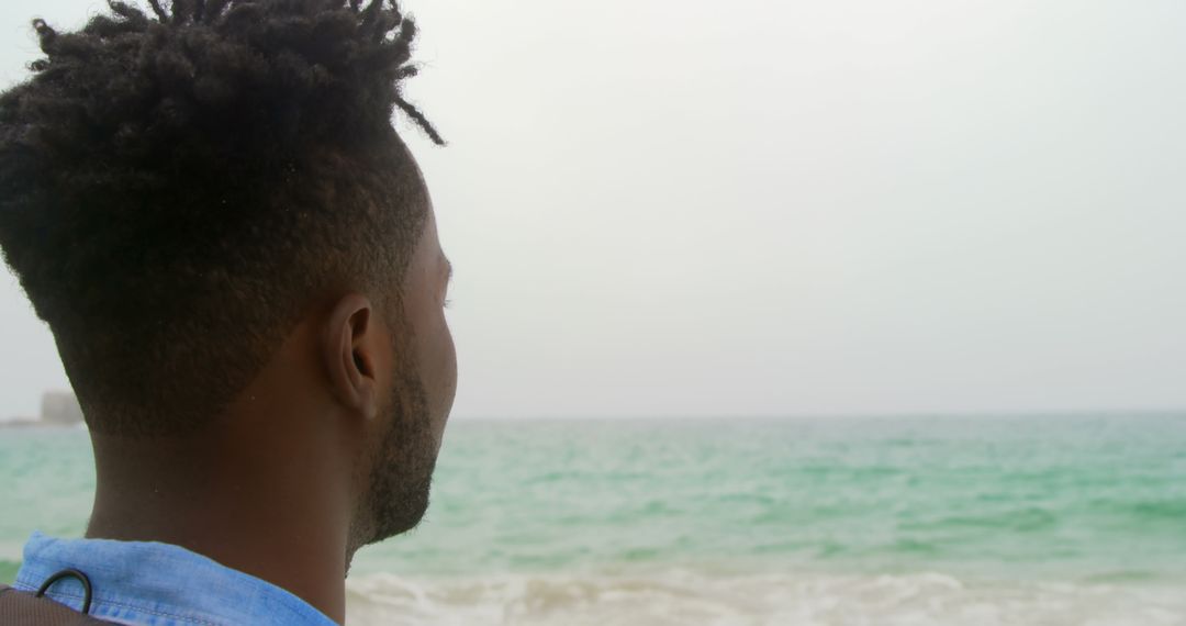 Man Gazing at Tranquil Ocean Horizon