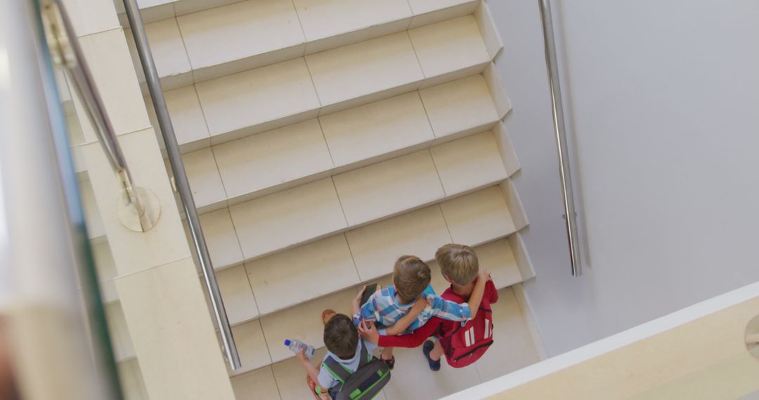 Boys Running Upstairs in School Captured from Above