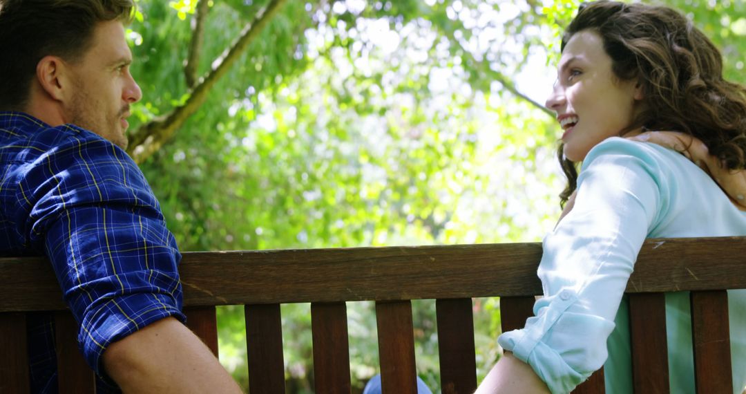 Young Couple Conversing on Park Bench in Relaxed Atmosphere
